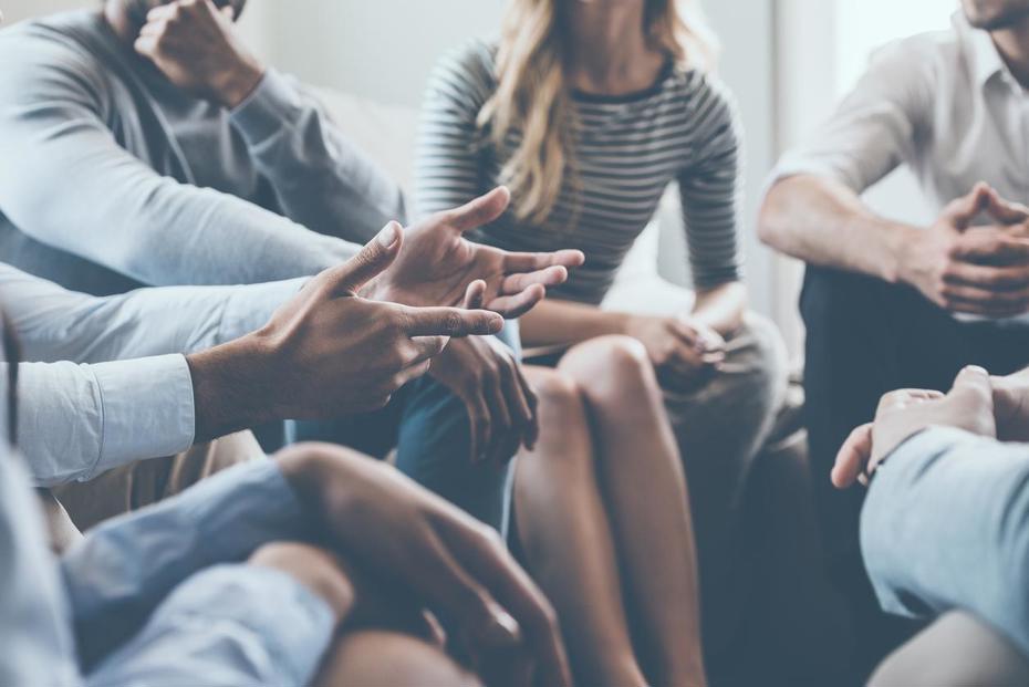 A group of people discussing 